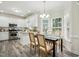 Bright kitchen and dining area featuring white cabinets, granite countertops, and stainless steel appliances at 3020 Woods Walk Way, Rocky Mount, NC 27804