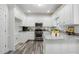 Modern kitchen with white cabinets, granite countertops, stainless steel appliances, and wood-look floors at 3020 Woods Walk Way, Rocky Mount, NC 27804