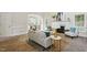 Open-concept living room with a fireplace, elegant decor, and seamless flow to the dining area at 3020 Woods Walk Way, Rocky Mount, NC 27804