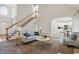 Elegant living room with high ceilings, a staircase, and an open view into the kitchen at 3020 Woods Walk Way, Rocky Mount, NC 27804