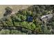 An aerial image featuring a triangular property line of a house hidden by dense foliage at 3070 Cameron Dr, Henderson, NC 27536