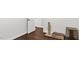 Bedroom area featuring dark wood floors, neutral paint, and some pet furniture at 3070 Cameron Dr, Henderson, NC 27536