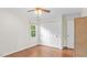 Well-lit bedroom featuring hardwood floors, neutral paint, and a window that offers view of the yard at 3070 Cameron Dr, Henderson, NC 27536