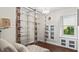 Bright bedroom with hardwood floors and walk-in closet, complemented by ample natural light and a chandelier at 3070 Cameron Dr, Henderson, NC 27536