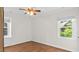 Bright bedroom with hardwood floors, neutral paint, and a large window that overlooks the outdoor greenery at 3070 Cameron Dr, Henderson, NC 27536