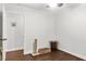 Cozy bedroom area featuring dark wood floors, neutral paint, and some pet furniture at 3070 Cameron Dr, Henderson, NC 27536