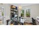 Warm breakfast nook featuring an elegant light fixture, hardwood floors, and ample natural light from the large window at 3070 Cameron Dr, Henderson, NC 27536
