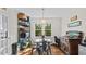 Well-lit breakfast nook featuring hardwood flooring, an elegant light fixture, and windows overlooking green backyard at 3070 Cameron Dr, Henderson, NC 27536