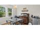 Charming breakfast nook with hardwood flooring, windows overlooking a green yard, and vintage cabinet at 3070 Cameron Dr, Henderson, NC 27536