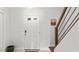 Bright entryway featuring a white front door and modern staircase at 3070 Cameron Dr, Henderson, NC 27536