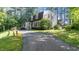 Charming home exterior features a long driveway and traditional architectural details surrounded by mature trees at 3070 Cameron Dr, Henderson, NC 27536