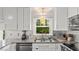 Bright kitchen features stainless steel appliances, granite countertops, and stylish backsplash at 3070 Cameron Dr, Henderson, NC 27536