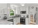 Well-equipped kitchen with white cabinetry, stainless steel appliances, and tile backsplash at 3070 Cameron Dr, Henderson, NC 27536