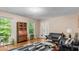 Cozy living room with hardwood flooring, large windows, black sofas, a glass coffee table and natural light at 3070 Cameron Dr, Henderson, NC 27536