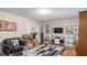 Inviting living room featuring a decorative area rug, hardwood flooring, a TV and a comfortable sofa at 3070 Cameron Dr, Henderson, NC 27536