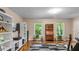 Relaxing living room featuring hardwood flooring, natural light, white bookshelves and a comfortable sofa at 3070 Cameron Dr, Henderson, NC 27536