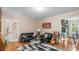 Comfortable living room featuring hardwood flooring, neutral walls, an area rug and plenty of natural light at 3070 Cameron Dr, Henderson, NC 27536