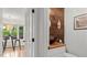 Charming powder room features wood accent wall and a vessel sink, complemented by French doors and a view to the outside at 3070 Cameron Dr, Henderson, NC 27536
