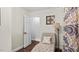 Cozy sitting area featuring a chaise lounge, decorative wall art, and stylish curtains at 3070 Cameron Dr, Henderson, NC 27536