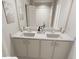 Modern bathroom with double sinks, vanity with storage, and a large mirror for convenience at 338 Cottage Hill Way, Knightdale, NC 27604