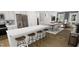 Bright kitchen with island and stainless steel appliances, open to the dining area and living room for seamless living at 338 Cottage Hill Way, Knightdale, NC 27604