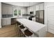 Bright modern kitchen with stainless appliances, white countertops, and center island with seating at 338 Cottage Hill Way, Knightdale, NC 27604