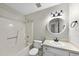 Bright bathroom featuring a tub-shower combo, toilet, and vanity with an oval mirror at 3427 Mill Run, Raleigh, NC 27612