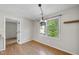 Dining room with natural light from the large window and wooden floors at 3427 Mill Run, Raleigh, NC 27612