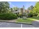 Exterior elevation of a multi-story home from the parking lot surrounded by mature trees at 3427 Mill Run, Raleigh, NC 27612