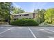 Exterior elevation of a multi-story home surrounded by mature trees and parking at 3427 Mill Run, Raleigh, NC 27612