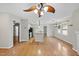 Open concept living room featuring hardwood floors, kitchen and fan at 3427 Mill Run, Raleigh, NC 27612