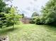Green backyard area surrounded by mature trees at 405 Foster Ln, Burlington, NC 27215