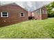 Brick home exterior with stairs leading to a small back door at 405 Foster Ln, Burlington, NC 27215