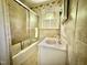 Bathroom with a shower/tub, window, tile walls and floors at 405 Foster Ln, Burlington, NC 27215