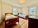 Bright bedroom with two twin beds, wood floors, and natural light at 405 Foster Ln, Burlington, NC 27215