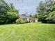 Quaint brick home with large front lawn, decorative shutters and detached garage at 405 Foster Ln, Burlington, NC 27215