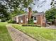 Traditional brick home with brick walkway and updated windows at 405 Foster Ln, Burlington, NC 27215