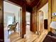 Hallway view of rooms with wood floors, door trim, and bright natural light at 405 Foster Ln, Burlington, NC 27215