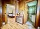 Hallway view of the bedroom and bathroom with wooden floors and door trim at 405 Foster Ln, Burlington, NC 27215
