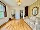 Living room with hardwood floors, large window with shutters, and views of the kitchen and dining room at 405 Foster Ln, Burlington, NC 27215