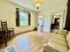 Bright living room with hardwood floors, a window with shutters, and vintage-style furniture at 405 Foster Ln, Burlington, NC 27215