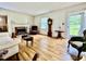 Living room with hardwood floors, a fireplace, and natural light, creating a cozy atmosphere at 405 Foster Ln, Burlington, NC 27215