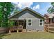 Back exterior showing the deck, backyard, and string lights; the home has a gray siding at 415 1St St, Apex, NC 27502