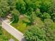 A spacious backyard with green lawn and mature trees, accessible by paved walkway and neighborhood street at 415 1St St, Apex, NC 27502
