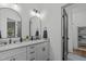 Beautiful bathroom featuring dual sinks, quartz countertop, and modern fixtures at 415 1St St, Apex, NC 27502