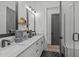 Stylish bathroom featuring double vanity with modern faucets, walk in shower, and elegant mirrors at 415 1St St, Apex, NC 27502