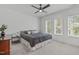 Bright bedroom featuring a ceiling fan, two windows, and neutral carpet at 415 1St St, Apex, NC 27502