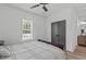 Well-lit bedroom features hardwood floors, a large window, and a closet with gray double doors at 415 1St St, Apex, NC 27502