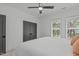 Bright bedroom featuring a ceiling fan, window, modern closet, and neutral carpet at 415 1St St, Apex, NC 27502
