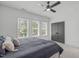 Bedroom showcasing soft carpet, many windows and a closet with gray doors at 415 1St St, Apex, NC 27502